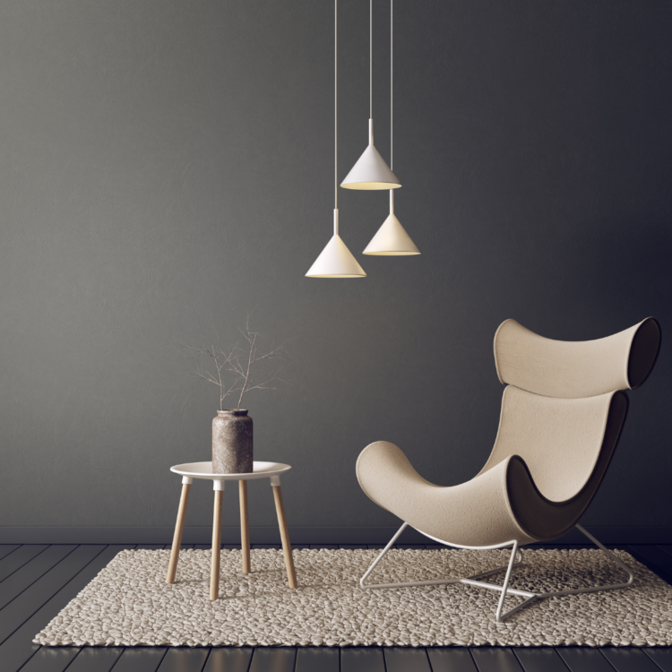 A white chair next to a white side table with a plant